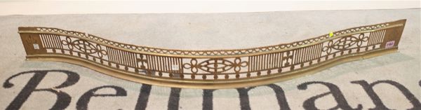 A Victorian brass bow fronted fire fender, with pierced decoration,120cm wide; 12cm high