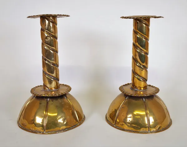 A pair of late 19th century brass candlesticks with cup bases and spiral stems