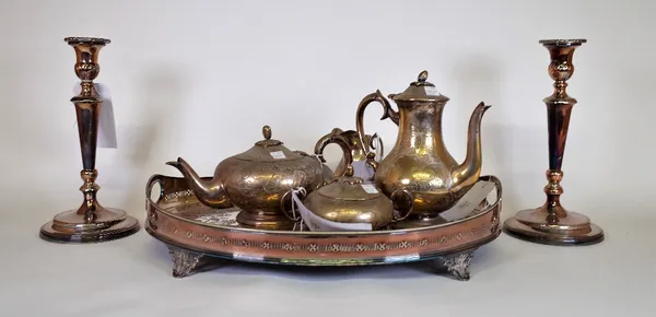 Silver plated wares including, an oval galleried tray, a pair of candlesticks and a four place tea set (qty).