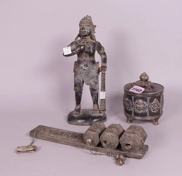 A early 20th century Tibetan box and cover, 9cm wide x 12cm high, an early 20th century patinated bronze figure of a deity, 26cm high,
