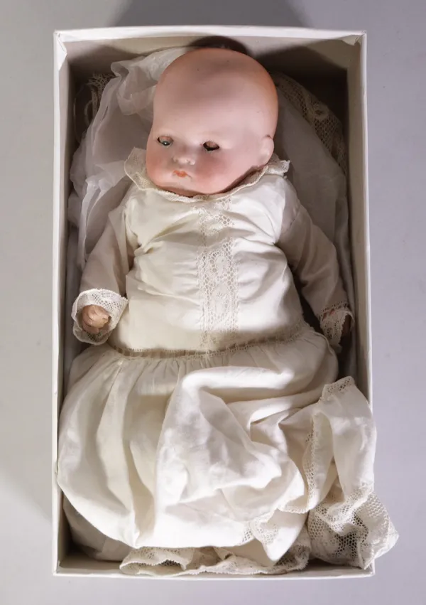 An early 20th century German doll with bisque head, 28cm long