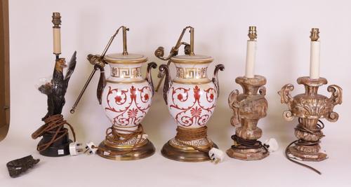 A pair of 19 century Italian gilt wood table lamps formed as urns, 45cm high, a black painted and parcel gilt decorated table lamp form as an eagle, 49cm high