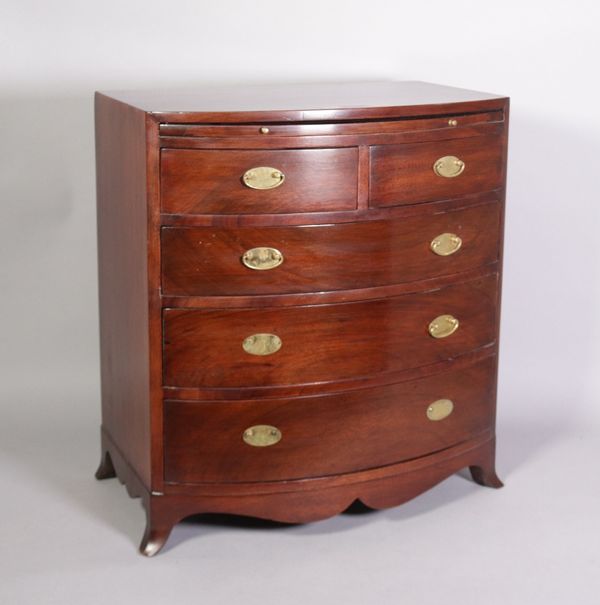 A George III style miniature bowfront chest with brushing slide over two short and three long graduated drawers.