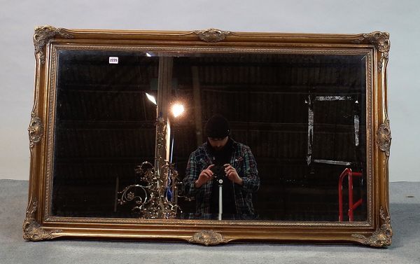 A modern gilt framed rectangular overmantel mirror with bevelled glass plate