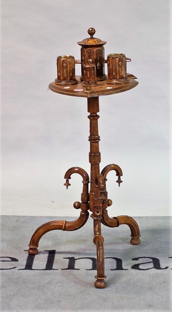 A late 19th century Continental gilt metal mounted stained beech smoker's stand, on a tripod base,