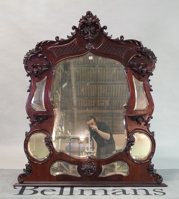 A late Victorian mahogany framed mirror back, with an arrangement of bevelled plates and shelves,