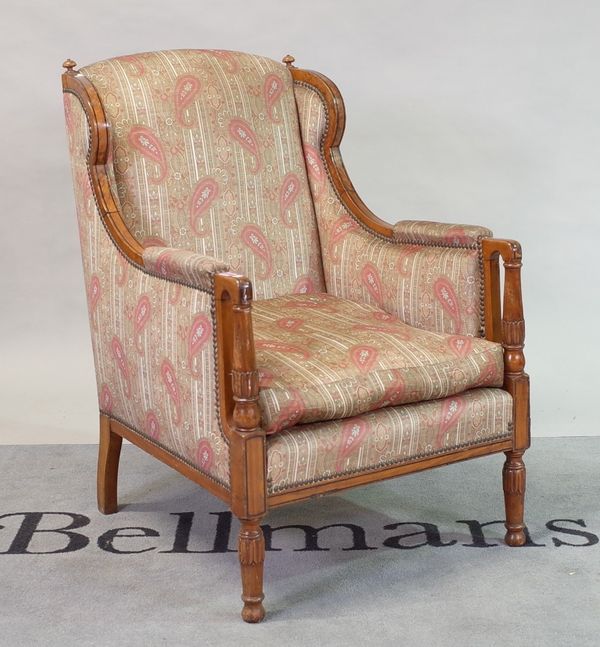 A late 19th century satinwood framed wingback easy armchair, on turned supports