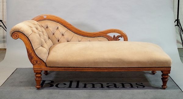 An Edwardian mahogany framed chaise longue with buttonback upholstery