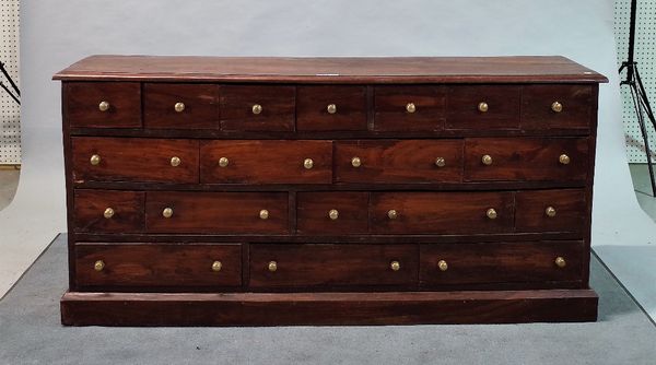 A 20th century hardwood apothecary chest with nineteen various drawers on plinth base