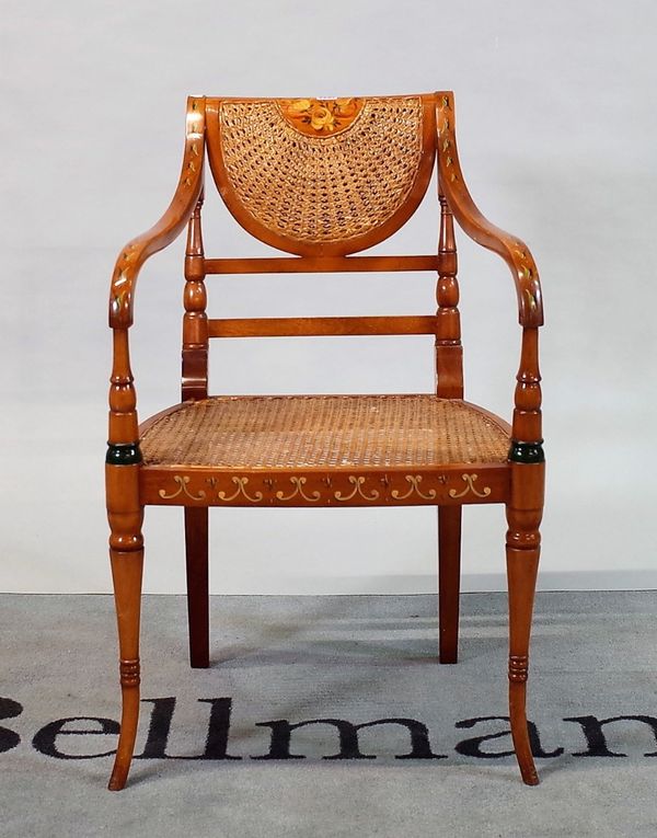 A Regency style mahogany open armchair with cane seat and floral painted decoration,