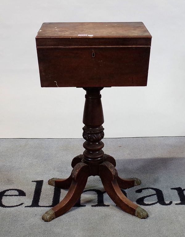 An early Victorian mahogany Cellarette on turned column and four downswept supports.