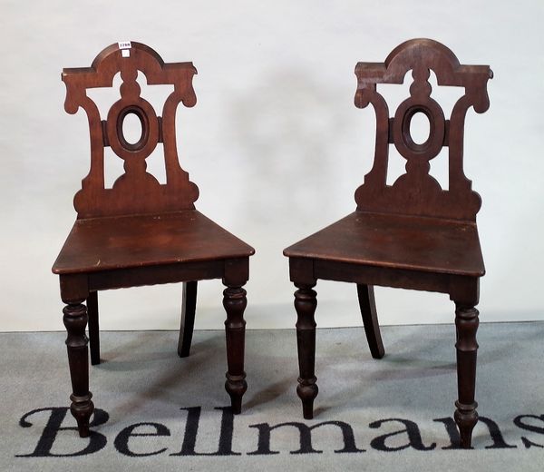 A pair of Victorian style mahogany hall chairs on turned supports (2)