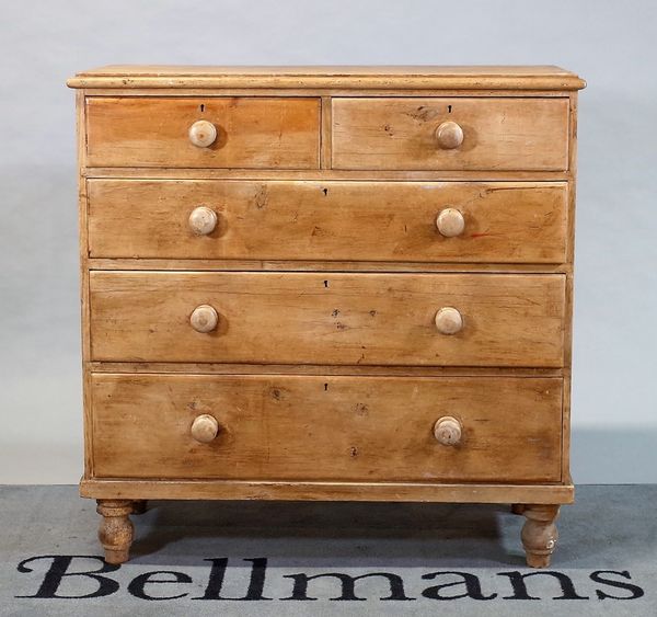 A Victorian pine desk of two short and three long graduated drawers on turned feet