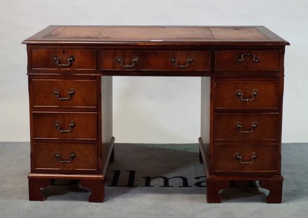 A modern mahogany pedestal desk, with inset leather top over nine drawers