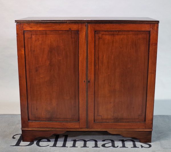 A late George III mahogany side cupboard on bracket feet