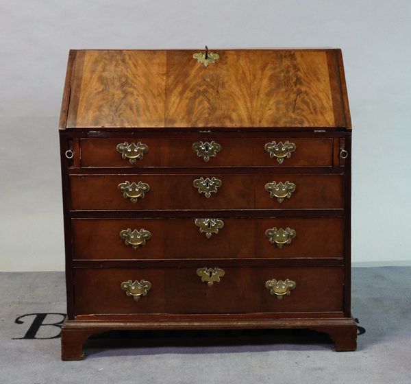 A George III mahogany bureau with four long graduated drawers