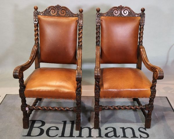 A pair of Victorian oak high back open armchairs on block supports