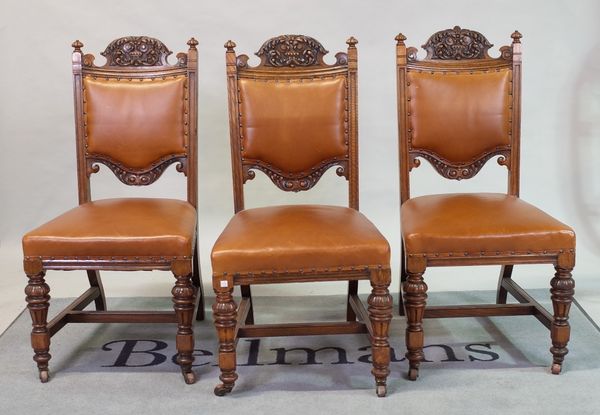 A set of six Victorian oak dining chairs with brown leather upholstery