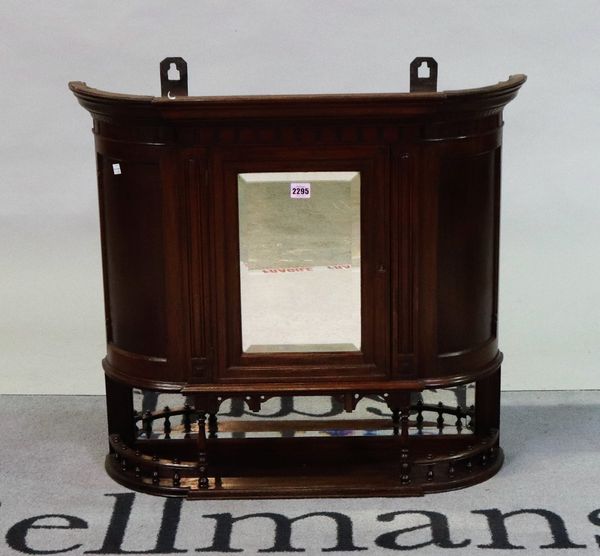 An Edwardian mahogany hanging cupboard with central bevelled mirror flanked by cupboard doors