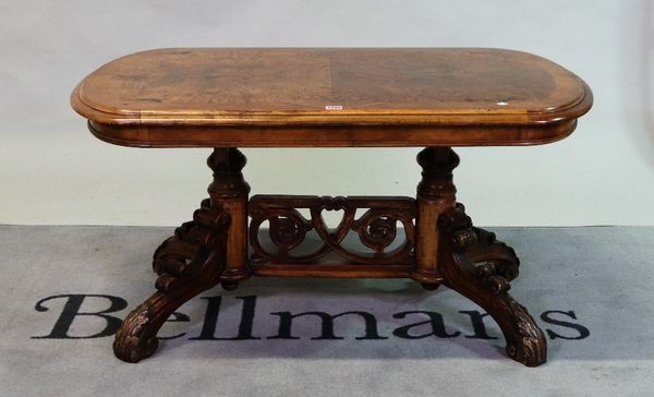 A Victorian burr walnut oval low table with pierced stretcher on four carved outswept supports