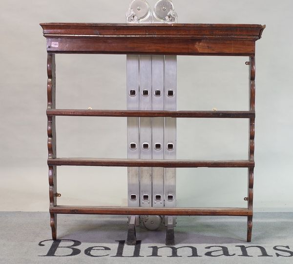 An 18th century oak hanging open three-tier wall shelf with shaped sides