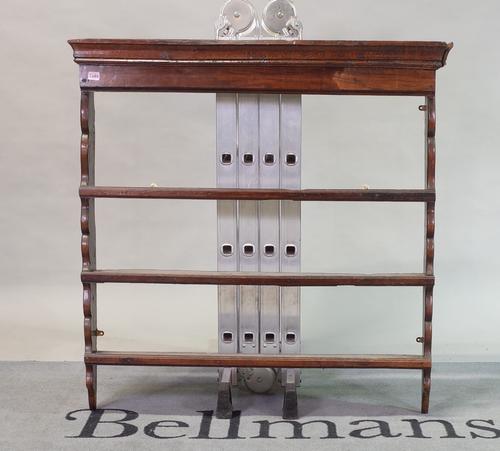 An 18th century oak hanging open three-tier wall shelf with shaped sides