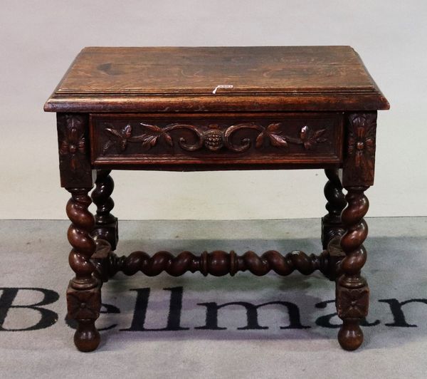 An 18th century style oak low side table with single carved drawer on spiral twisted supports