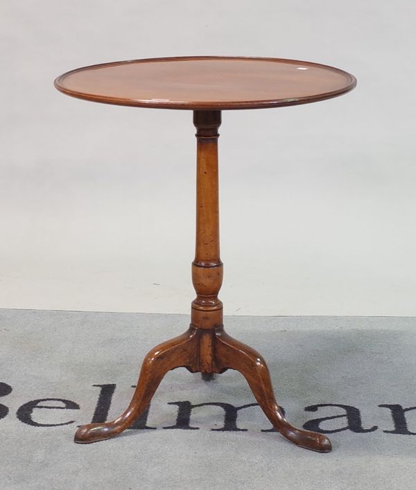 A George III mahogany tripod table with dished top on downswept supports