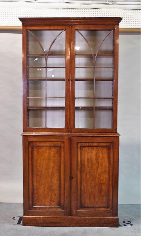 An early Victorian mahogany bookcase cabinet on plinth base