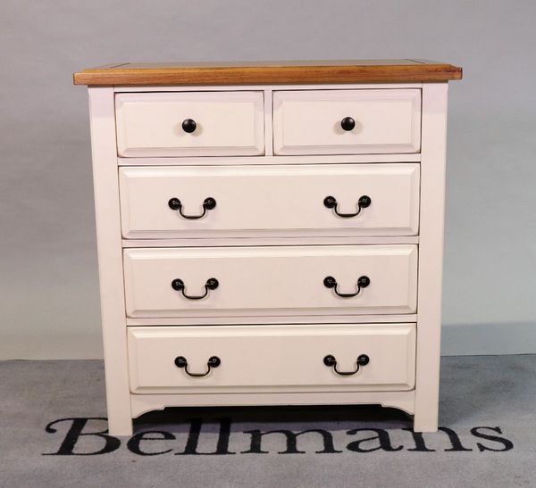 A modern white painted chest with oak top over two short and three long drawers