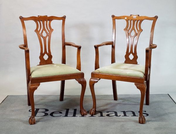 A pair of George III style mahogany open armchairs on ball and claw supports