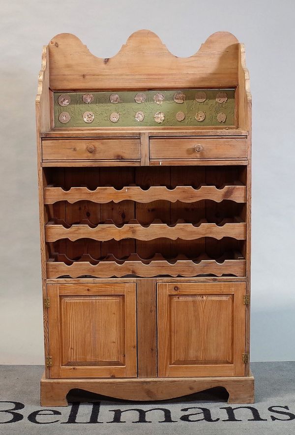 A modern pine side cabinet with three tier wine rack over a cupboard base