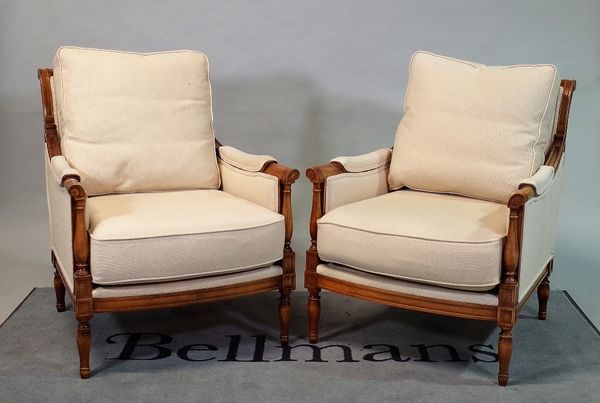 'Wesley Barrell', a pair of modern stained beech framed armchairs on turned supports