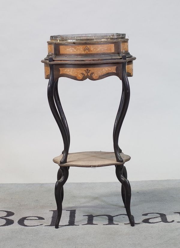 A Continental walnut and ebonised jardinere stand with shaped legs united by undertier