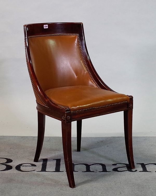 A Regency style mahogany and brown leather tub chair