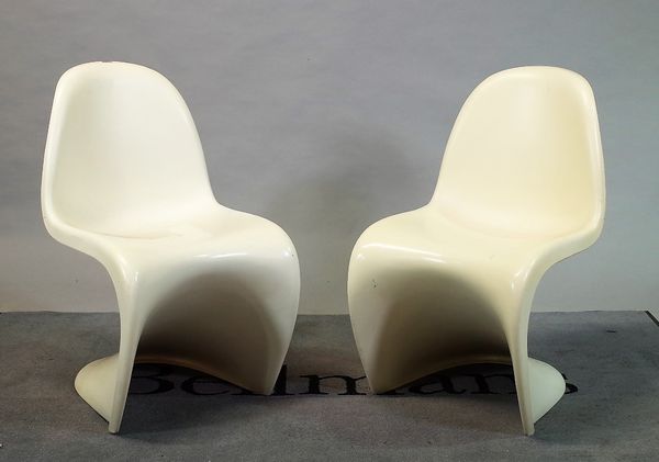 Probably Verner Panton, two one piece moulded, white plastic chairs