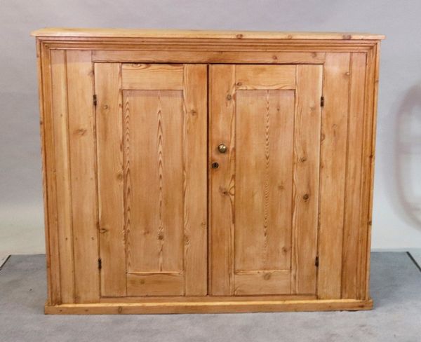 An early 20th century pine side cupboard on a plinth base