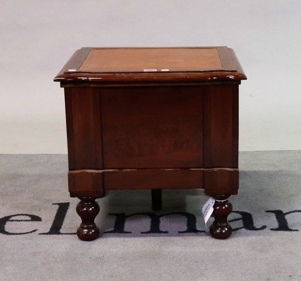 A 19th century mahogany commode with inset leather top on turned supports