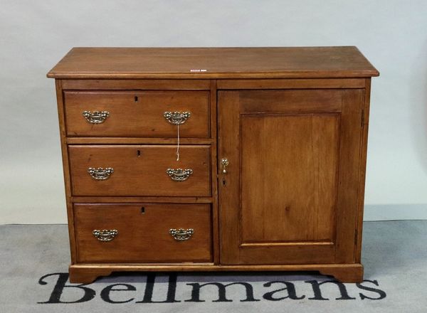 An early 20th century fruitwood side cabinet with three short drawers