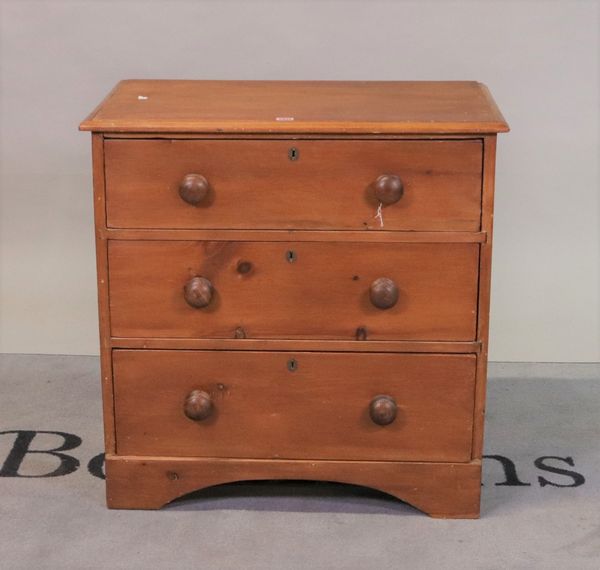 An early 20th century pine chest of three long drawers