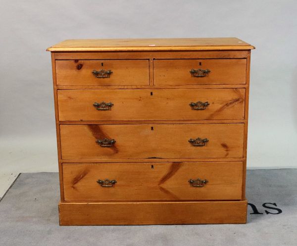 An Edwardian pine chest of two short and three long graduated drawers