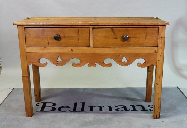 An early 20th century pine kitchen dresser with a three-tier plate rack over two frieze drawers