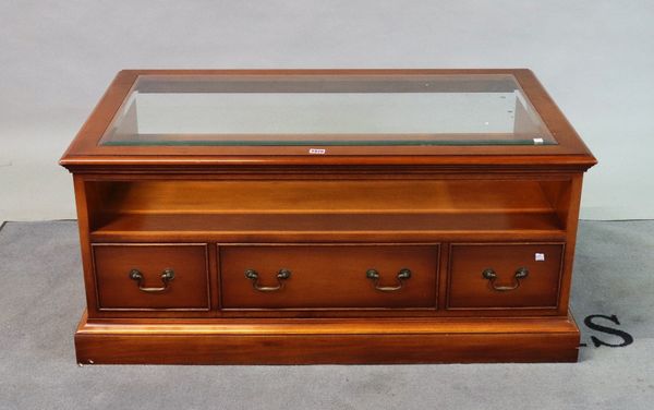 A modern yew wood rectangular coffee table with inset glass top