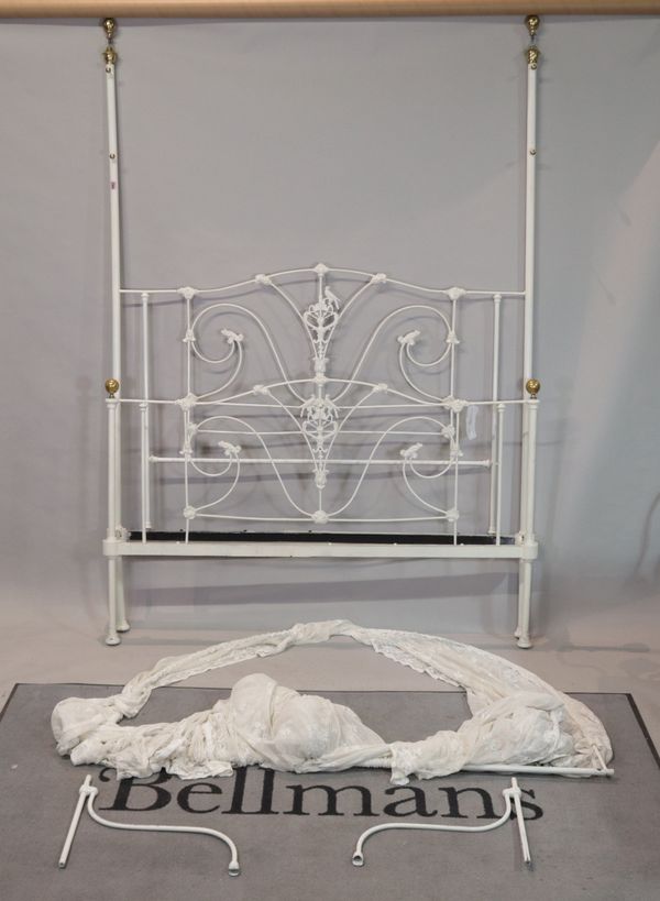 A modern white painted metal double bed