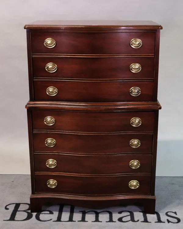 A modern stained beech serpentine chest on chest