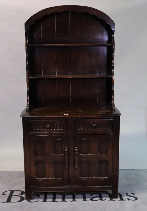 A modern oak dresser with two tier arch top back, over the base with a pair of drawers and cupboards.