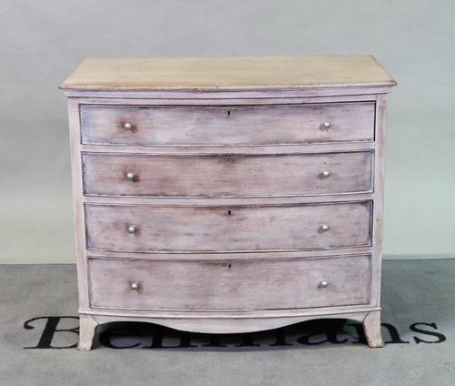 A modern grey painted bowfront chest of four long graduated drawers