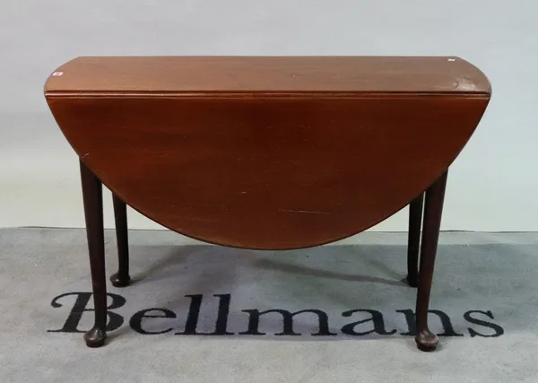 A George II mahogany oval drop flap table on pad feet