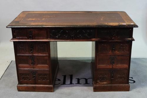 A carved oak kneehole desk, early 20th century, in period style