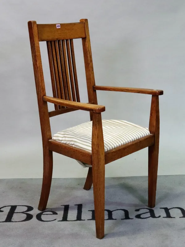 An Arts & Crafts oak open armchair on tapering square supports, 60cm wide; 115cm high.